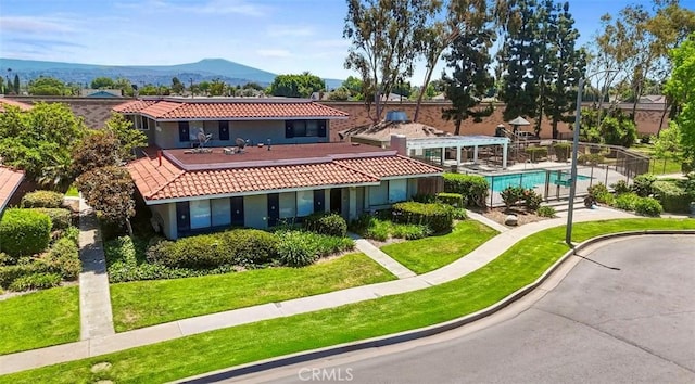 2413 N Deodar St Unit 3, Santa Ana, CA 92705 - back of property featuring a tile roof, stucco siding, a yard, and a mountain view