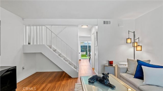 2413 N Deodar St Unit 3, Santa Ana, CA 92705 - living room featuring wood finished floors, stairs, and baseboards