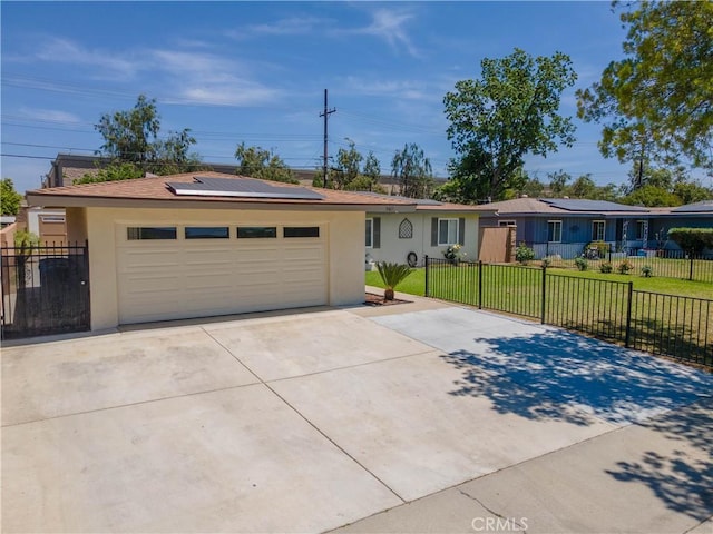 5611 Harold St, Riverside, CA 92503 - ranch-style house featuring stucco siding, concrete driveway, solar panels, and an attached garage