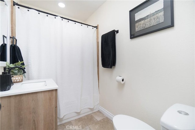 5611 Harold St, Riverside, CA 92503 - bathroom featuring toilet, vanity, baseboards, and shower / bath combination with curtain