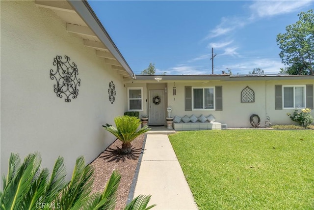 5611 Harold St, Riverside, CA 92503 - entrance to property featuring stucco siding and a yard