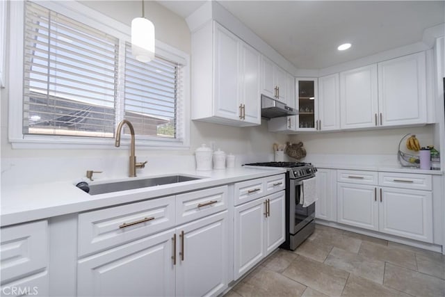 5611 Harold St, Riverside, CA 92503 - kitchen featuring stainless steel range with gas cooktop, under cabinet range hood, a sink, white cabinetry, and recessed lighting