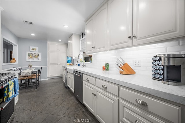 4538 Conquista Ave, Lakewood, CA 90713 - kitchen featuring stainless steel appliances, tasteful backsplash, white cabinetry, and recessed lighting