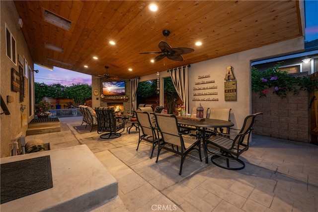 4538 Conquista Ave, Lakewood, CA 90713 - view of patio with a lit fireplace, outdoor dining area, and ceiling fan