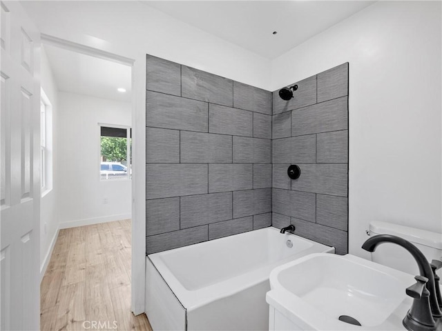 257 W 11th St, San Bernardino, CA 92410 - full bathroom featuring a sink, washtub / shower combination, wood finished floors, baseboards, and recessed lighting
