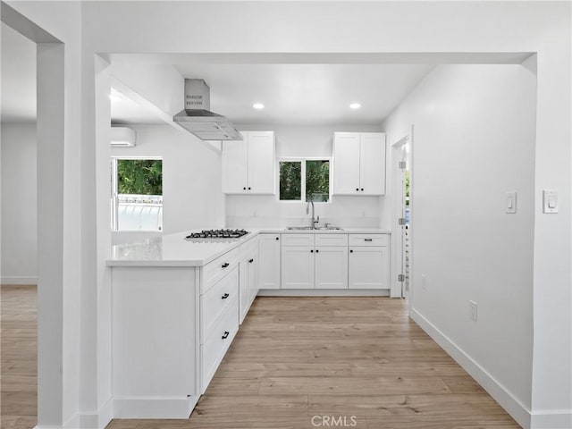 257 W 11th St, San Bernardino, CA 92410 - kitchen with a sink, wall chimney exhaust hood, stainless steel gas stovetop, plenty of natural light, and recessed lighting