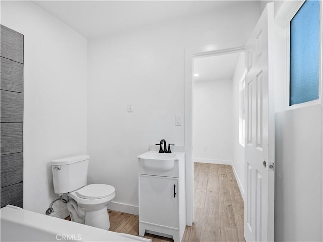257 W 11th St, San Bernardino, CA 92410 - bathroom with vanity, toilet, wood finished floors, baseboards, and recessed lighting