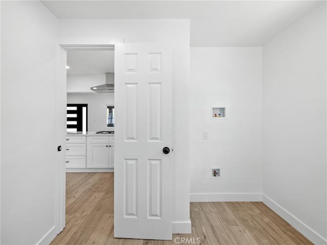 257 W 11th St, San Bernardino, CA 92410 - washroom featuring hookup for a washing machine, light wood finished floors, and baseboards