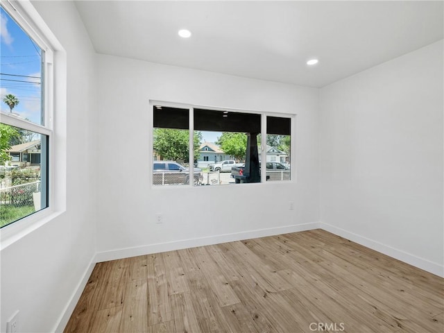 257 W 11th St, San Bernardino, CA 92410 - empty room with wood finished floors, plenty of natural light, baseboards, and recessed lighting