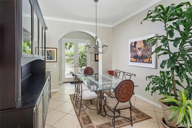 26800 Fairlain Dr, Valencia, CA 91355 - dining area featuring french doors, light tile patterned floors, ornamental molding, a chandelier, and arched walkways