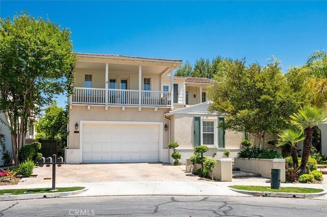 26800 Fairlain Dr, Valencia, CA 91355 - view of front of home featuring a balcony, an attached garage, concrete driveway, stucco siding, and brick siding