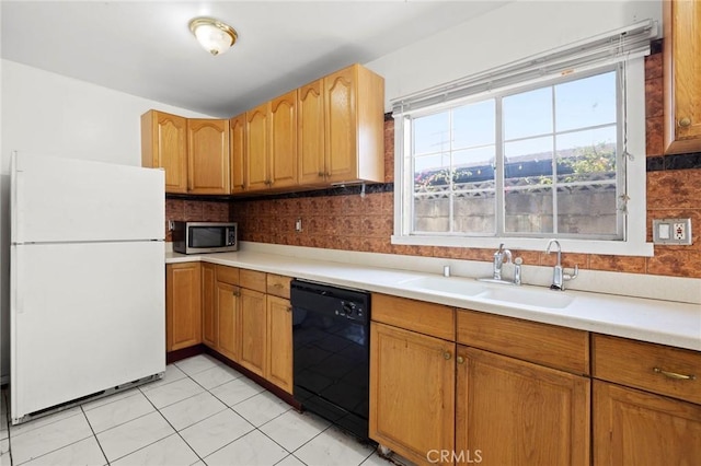1222 N Virgil Ave, Los Angeles, CA 90029 - kitchen with freestanding refrigerator, dishwasher, stainless steel microwave, a sink, and light countertops