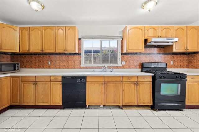 1222 N Virgil Ave, Los Angeles, CA 90029 - kitchen with black appliances, under cabinet range hood, light countertops, decorative backsplash, and light tile patterned floors