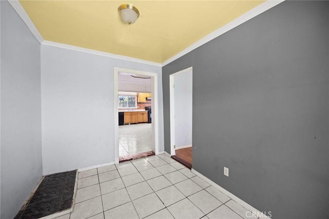 1222 N Virgil Ave, Los Angeles, CA 90029 - spare room featuring crown molding, baseboards, and light tile patterned floors