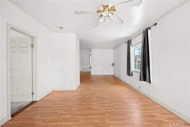 1222 N Virgil Ave, Los Angeles, CA 90029 - empty room with light wood finished floors, ceiling fan, and baseboards