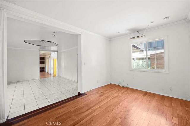 1222 N Virgil Ave, Los Angeles, CA 90029 - unfurnished room with crown molding, wood finished floors, and baseboards