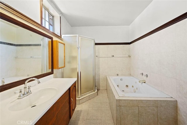 1222 N Virgil Ave, Los Angeles, CA 90029 - full bath featuring vanity, a stall shower, a tub with jets, tile patterned floors, and tile walls