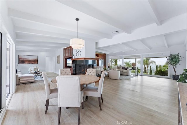 1929 Dorothea Rd, La Habra Heights, CA 90631 - dining space with beam ceiling, a multi sided fireplace, and light wood finished floors