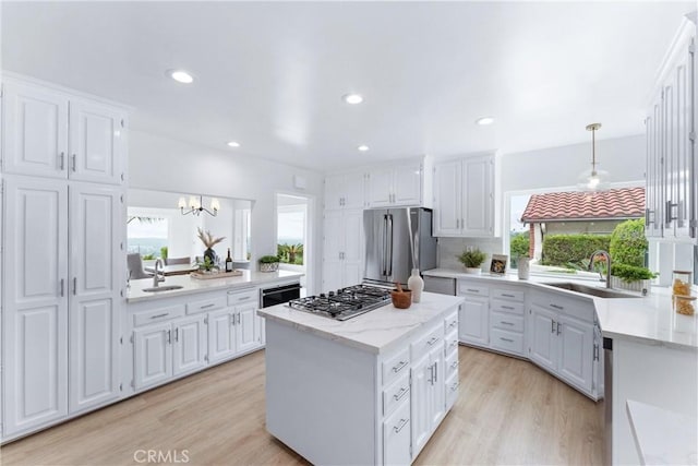1929 Dorothea Rd, La Habra Heights, CA 90631 - kitchen with appliances with stainless steel finishes, a sink, white cabinetry, a kitchen island, and recessed lighting