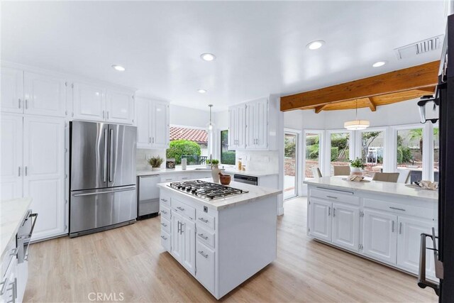 1929 Dorothea Rd, La Habra Heights, CA 90631 - kitchen with appliances with stainless steel finishes, white cabinets, light wood-style floors, beamed ceiling, and decorative light fixtures