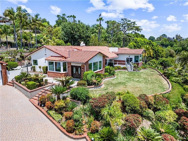 1929 Dorothea Rd, La Habra Heights, CA 90631 - mediterranean / spanish house with a tile roof, stucco siding, a front lawn, and a chimney