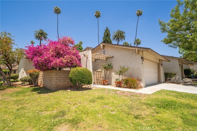 2627 Mangrove Way, Riverside, CA 92506 - view of front of home with stucco siding, a garage, driveway, and a front lawn