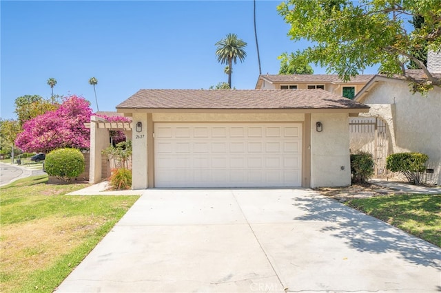 2627 Mangrove Way, Riverside, CA 92506 - view of front facade featuring stucco siding, driveway, an attached garage, and a front yard