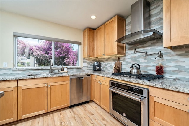 2627 Mangrove Way, Riverside, CA 92506 - kitchen featuring appliances with stainless steel finishes, wall chimney range hood, a sink, backsplash, and light wood finished floors