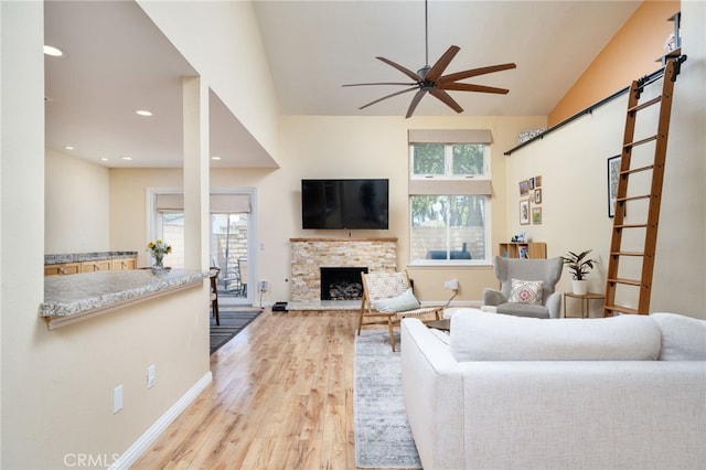 2627 Mangrove Way, Riverside, CA 92506 - living room with ceiling fan, wood finished floors, a stone fireplace, recessed lighting, and lofted ceiling