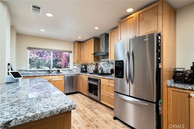 2627 Mangrove Way, Riverside, CA 92506 - kitchen featuring stainless steel appliances, wall chimney exhaust hood, light wood-type flooring, a sink, and backsplash
