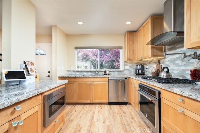 2627 Mangrove Way, Riverside, CA 92506 - kitchen featuring appliances with stainless steel finishes, wall chimney exhaust hood, light wood-style floors, decorative backsplash, and light stone counters