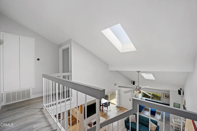 3125 Harbor Blvd, Oxnard, CA 93035 - corridor with a skylight, lofted ceiling, wood finished floors, and an upstairs landing