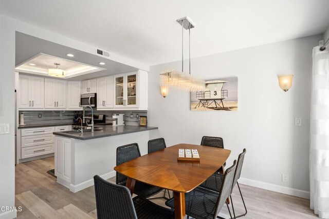 3125 Harbor Blvd, Oxnard, CA 93035 - dining room with light wood finished floors, recessed lighting, and a raised ceiling