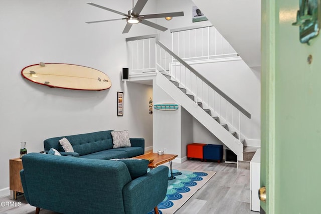 3125 Harbor Blvd, Oxnard, CA 93035 - living area with stairway, ceiling fan, wood finished floors, and a high ceiling
