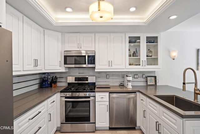 3125 Harbor Blvd, Oxnard, CA 93035 - kitchen with appliances with stainless steel finishes, a tray ceiling, white cabinetry, and recessed lighting