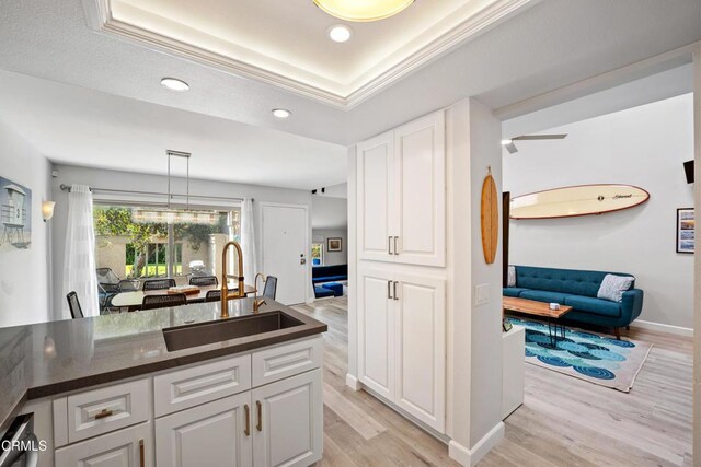 3125 Harbor Blvd, Oxnard, CA 93035 - kitchen featuring dark countertops, white cabinetry, light wood finished floors, and recessed lighting