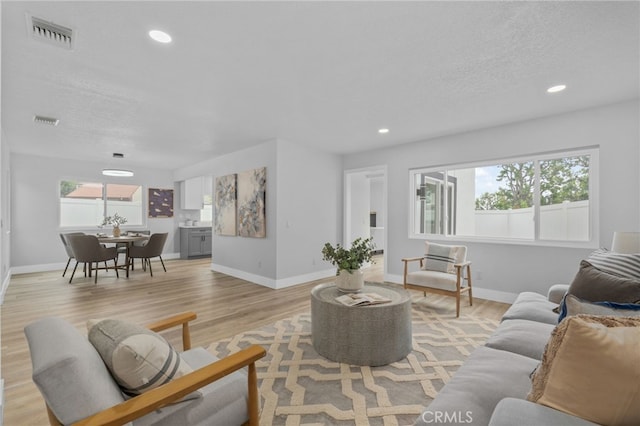 1468 Lemon Grove Dr, Upland, CA 91786 - living area with light wood-type flooring, baseboards, a textured ceiling, and recessed lighting