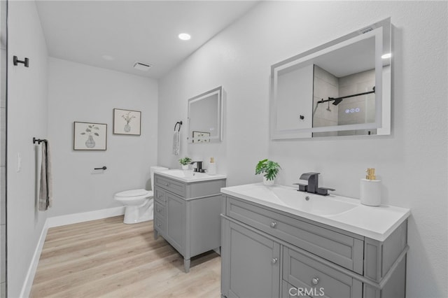 1468 Lemon Grove Dr, Upland, CA 91786 - bathroom with two vanities, toilet, wood finished floors, baseboards, and a tile shower