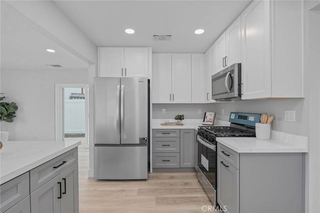 1468 Lemon Grove Dr, Upland, CA 91786 - kitchen featuring stainless steel appliances, gray cabinets, light wood-type flooring, recessed lighting, and white cabinetry