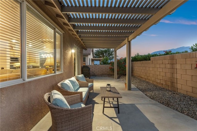 65565 Acoma Ave Unit 1, Desert Hot Springs, CA 92240 - fenced backyard featuring a patio, a pergola, a mountain view, and an outdoor living space