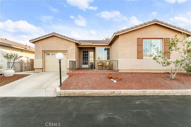 65565 Acoma Ave Unit 1, Desert Hot Springs, CA 92240 - single story home featuring concrete driveway, stucco siding, a garage, and a tiled roof