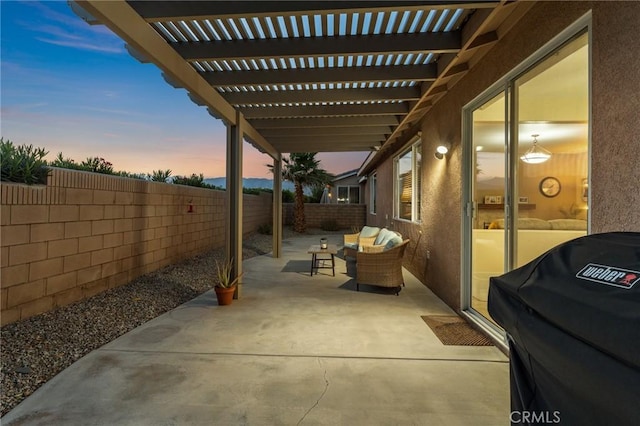 65565 Acoma Ave Unit 1, Desert Hot Springs, CA 92240 - patio terrace at dusk with grilling area, a fenced backyard, a pergola, outdoor lounge area, and a patio area