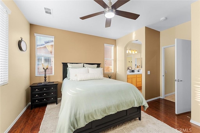 65565 Acoma Ave Unit 1, Desert Hot Springs, CA 92240 - bedroom featuring wood finished floors, arched walkways, ensuite bathroom, and a ceiling fan