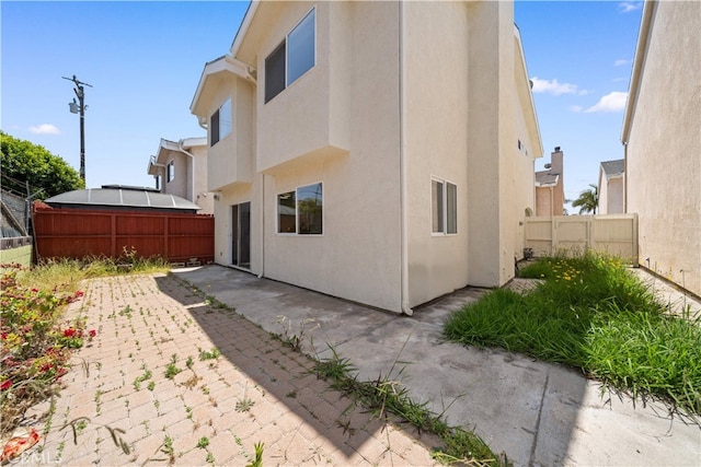 4431 W 138th St Unit B, Hawthorne, CA 90250 - rear view of house with a fenced backyard, a patio, and stucco siding