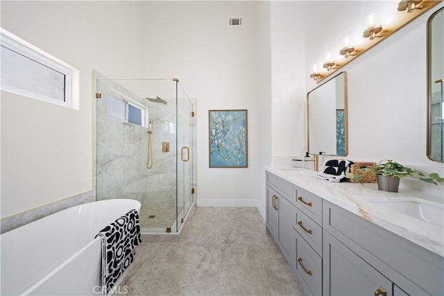 4431 W 138th St Unit B, Hawthorne, CA 90250 - full bath featuring a stall shower, a soaking tub, double vanity, and baseboards