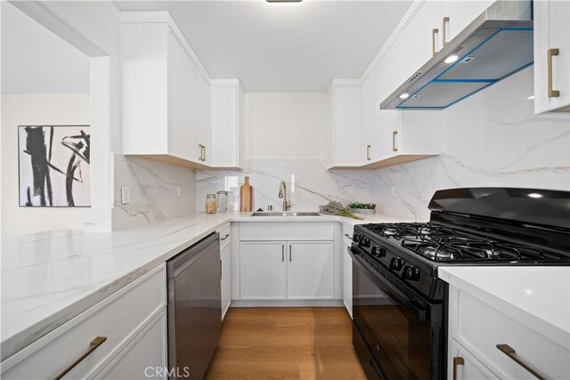 4431 W 138th St Unit B, Hawthorne, CA 90250 - kitchen with black gas stove, stainless steel dishwasher, wall chimney exhaust hood, a sink, and white cabinets