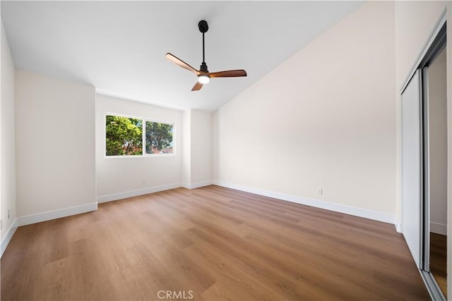 4431 W 138th St Unit B, Hawthorne, CA 90250 - unfurnished bedroom with light wood-style floors, vaulted ceiling, baseboards, a closet, and ceiling fan