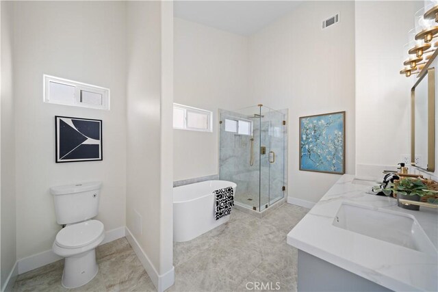 4431 W 138th St Unit B, Hawthorne, CA 90250 - bathroom with double vanity, a freestanding bath, toilet, a shower stall, and baseboards