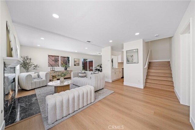 4431 W 138th St Unit B, Hawthorne, CA 90250 - living room featuring stairs, a fireplace, light wood-type flooring, recessed lighting, and baseboards