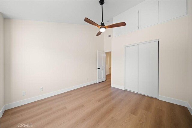 4431 W 138th St Unit B, Hawthorne, CA 90250 - unfurnished bedroom with light wood finished floors, baseboards, a high ceiling, a closet, and ceiling fan